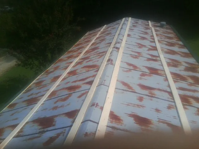 Rusted metal roof panels with new wood purlins before replacement — Storm Damage Roof Repair in Pleasant Lake by Roofing Brothers
